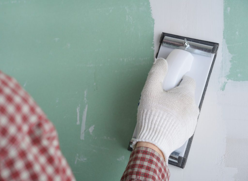 Person sanding drywall