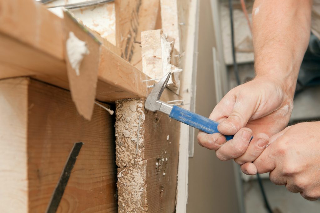Carpenter Using a Nail Puller nail puller to remove nails