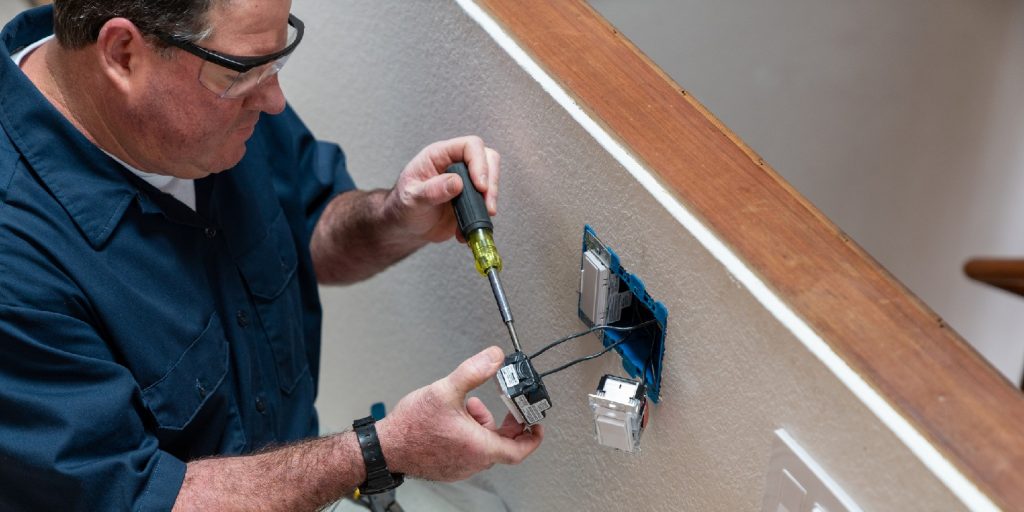 install-an-electrical-box woodsmith Electrician installing light switch in home