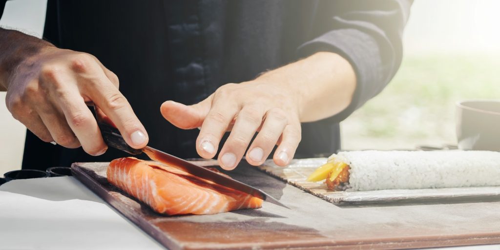 Chef cook making sushi outdoor