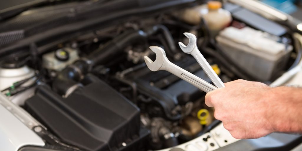 Mechanic holding two types of wrench