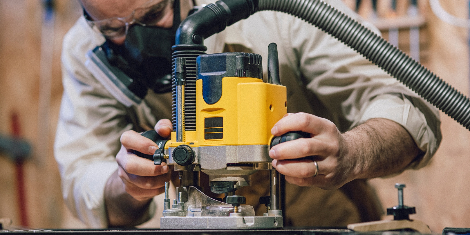 Carpenter Using a Router in a Workshop