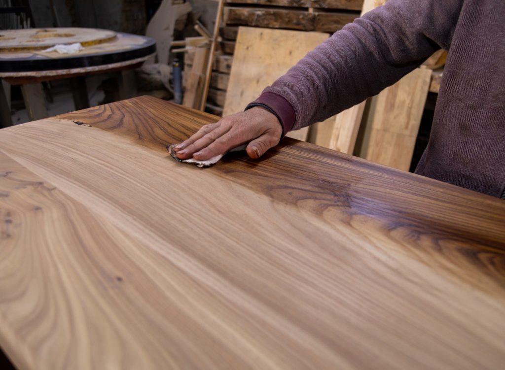 Man applying coating to a wooden table