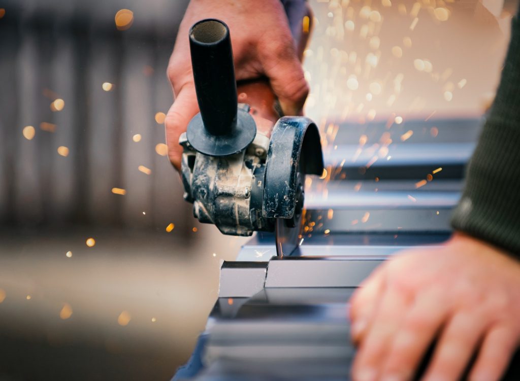 Man cutting metal with an angle grinder