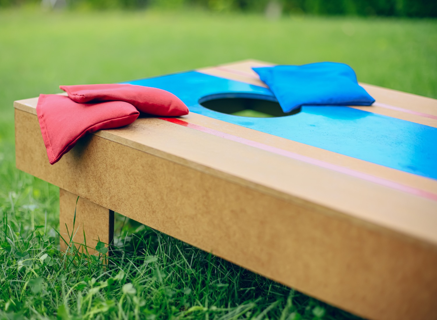 A Cornhole Board on a lawn.
