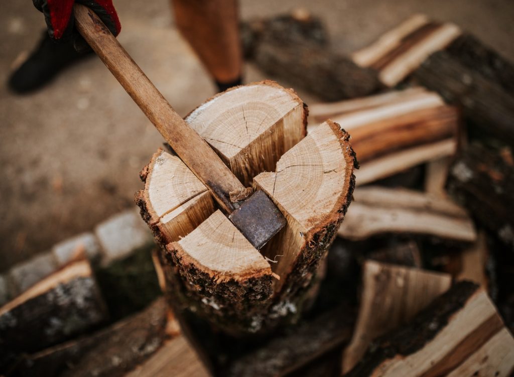 Man splitting wood with an axe