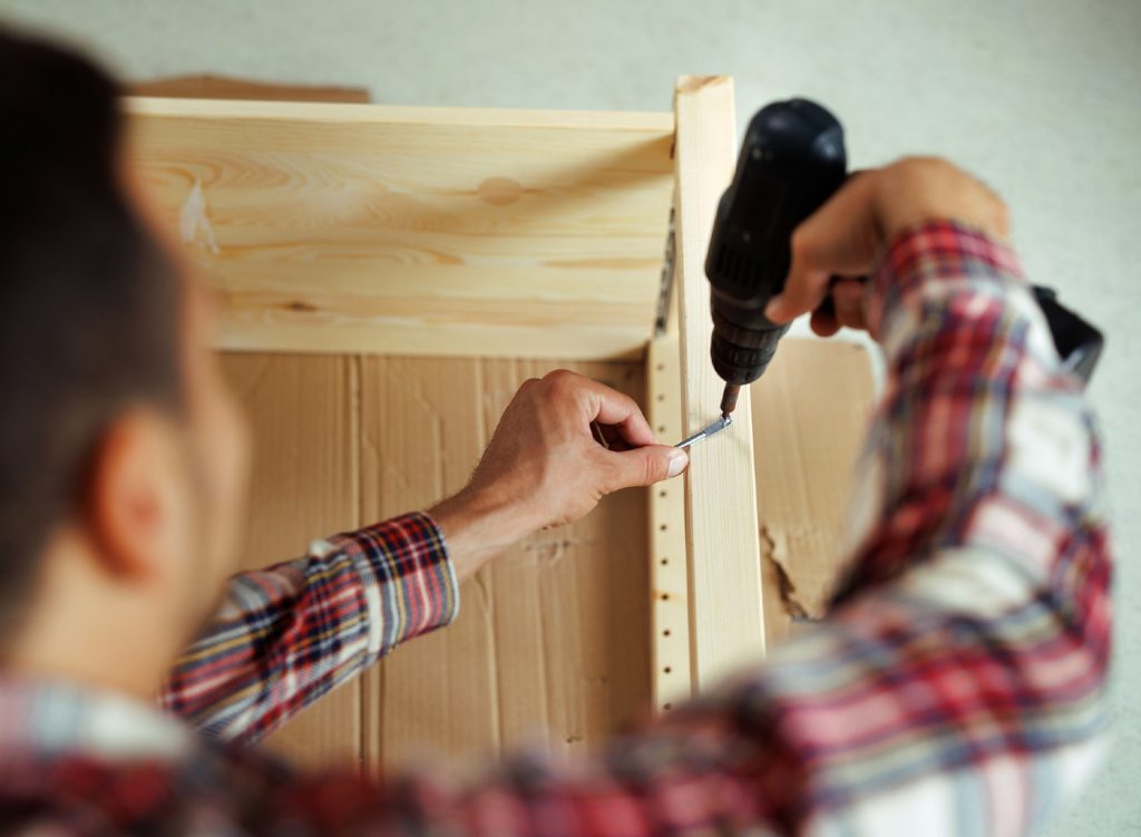 Man building wood shelves